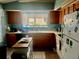 Kitchen with wood cabinets, light blue walls, and island at 132 Meadow Blvd, Sanford, FL 32771