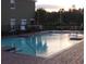 Community pool with brick patio and surrounding greenery at 3514 Victoria Pines Dr # 148, Orlando, FL 32829