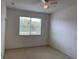 Bright bedroom with window and ceiling fan at 3514 Victoria Pines Dr # 148, Orlando, FL 32829