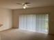 Living room with sliding glass doors and neutral carpeting at 3514 Victoria Pines Dr # 148, Orlando, FL 32829