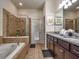 Primary bathroom with soaking tub, double vanity, and walk-in shower at 8887 Qin Loop, Kissimmee, FL 34747
