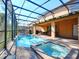 Inviting screened pool and spa with brick pavers at 8887 Qin Loop, Kissimmee, FL 34747