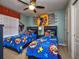 Themed bedroom with twin beds and superhero decor at 8887 Qin Loop, Kissimmee, FL 34747