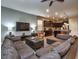 Spacious living room with sectional sofa and large TV at 8887 Qin Loop, Kissimmee, FL 34747