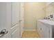Bright laundry room with washer, dryer, and storage at 8887 Qin Loop, Kissimmee, FL 34747