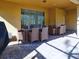 Covered patio with wicker furniture and brick flooring at 8887 Qin Loop, Kissimmee, FL 34747