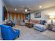 Bright Gathering room featuring a sectional sofa and accent wall at 8887 Qin Loop, Kissimmee, FL 34747