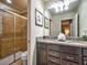 Bathroom with granite countertop, double vanity, and shower at 8887 Qin Loop, Kissimmee, FL 34747