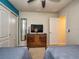 Bedroom with two twin beds, dresser, and TV at 8887 Qin Loop, Kissimmee, FL 34747