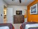 Bedroom with twin beds, dresser and access to living area at 8887 Qin Loop, Kissimmee, FL 34747