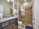 Bathroom with a walk-in shower and granite countertop at 8887 Qin Loop, Kissimmee, FL 34747