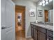 Bathroom with granite countertop and dark brown cabinets at 8887 Qin Loop, Kissimmee, FL 34747