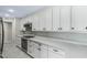 Modern kitchen with white cabinets, quartz countertops, and stainless steel appliances at 311 E Morse Blvd # 7-2, Winter Park, FL 32789