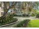 Tranquil courtyard with a water fountain, lush landscaping, and a large shade tree at 311 E Morse Blvd # 7-2, Winter Park, FL 32789