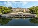 Aerial view of waterfront condo building with boat slips and lush landscaping at 311 E Morse Blvd # 7-2, Winter Park, FL 32789