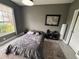 Cozy bedroom with a comfortable bed, large window, and world map decor at 5525 Pga Blvd # 4614, Orlando, FL 32839