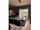 Living room with gray couch, black chairs, and lake view at 5525 Pga Blvd # 4614, Orlando, FL 32839