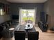 Living room with gray couch, black chairs, and lake view at 5525 Pga Blvd # 4614, Orlando, FL 32839