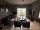 Bright living room with a sofa, coffee table, and lake view from sliding glass doors at 5525 Pga Blvd # 4614, Orlando, FL 32839