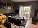 Living room with gray couch, black chairs, and lake view at 5525 Pga Blvd # 4614, Orlando, FL 32839