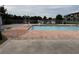 Inviting community pool with brick deck and lake view at 5525 Pga Blvd # 4614, Orlando, FL 32839