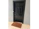 Black front door with brown doormat, located in a gray building at 5525 Pga Blvd # 4614, Orlando, FL 32839