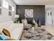 Bright living room features a white sofa, patterned armchair, and stylish geometric rug at 333 Navarra Ln, Davenport, FL 33837