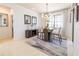 Modern dining room with glass-top table, four chairs, and an elegant chandelier at 333 Navarra Ln, Davenport, FL 33837