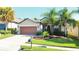 One-story house with attached garage and landscaped front yard at 333 Navarra Ln, Davenport, FL 33837