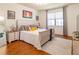 Main bedroom with king-size bed, hardwood floors, and large window at 333 Navarra Ln, Davenport, FL 33837