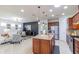 Open concept kitchen with large island, granite countertops, and stainless steel appliances at 333 Navarra Ln, Davenport, FL 33837
