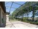 Spacious screened patio with brick pavers and lush landscaping at 333 Navarra Ln, Davenport, FL 33837