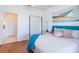 Serene bedroom with teal headboard and wood floors at 333 Navarra Ln, Davenport, FL 33837