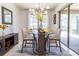 Bright dining room with glass-top table, four chairs, and access to a patio at 333 Navarra Ln, Davenport, FL 33837
