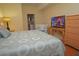 King-size bed, TV, and crib in bedroom with hardwood floors at 4011 Venetian Bay Dr # 101, Kissimmee, FL 34741