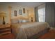 King-size bed in bright bedroom with hardwood floors and nightstands at 4011 Venetian Bay Dr # 101, Kissimmee, FL 34741