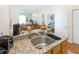 Kitchen boasts granite countertops, stainless steel sink, and modern appliances at 4011 Venetian Bay Dr # 101, Kissimmee, FL 34741