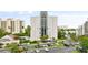 Aerial view of waterfront condo building with parking and pool at 6165 Carrier Dr # 1214, Orlando, FL 32819