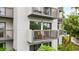 Condo building showcasing multiple balconies and surrounding greenery at 6165 Carrier Dr # 1214, Orlando, FL 32819