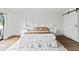 Bright bedroom with wood flooring, barn door, and neutral decor at 6165 Carrier Dr # 1214, Orlando, FL 32819