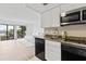 Modern galley kitchen with granite countertops and stainless steel appliances at 6165 Carrier Dr # 1214, Orlando, FL 32819