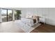 Spacious bedroom with wood-look floors and access to balcony at 6165 Carrier Dr # 1214, Orlando, FL 32819