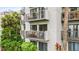 Condo building with balconies and lush landscaping at 6165 Carrier Dr # 1214, Orlando, FL 32819