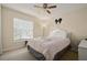 Spacious bedroom with a queen-size bed and window coverings at 619 Kensington Dr, Davenport, FL 33897
