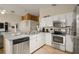 Kitchen with stainless steel appliances and white cabinets at 619 Kensington Dr, Davenport, FL 33897