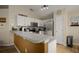 Kitchen with stainless steel appliances and white cabinets at 619 Kensington Dr, Davenport, FL 33897