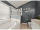 Bathroom with a garden tub, double vanity, and gray walls at 619 Kensington Dr, Davenport, FL 33897