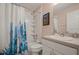 Clean bathroom with a shower/tub combo, cactus-themed shower curtain, and white vanity at 619 Kensington Dr, Davenport, FL 33897
