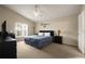 Spacious main bedroom with a king-size bed, large window, and dark wood furniture at 619 Kensington Dr, Davenport, FL 33897