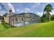 Inviting screened-in pool and patio area with lush landscaping at 633 Copeland Dr, Haines City, FL 33844